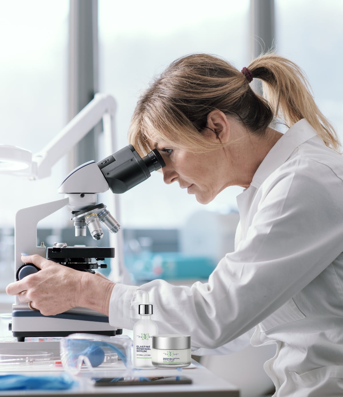 Scientist examining samples under microscope in lab.